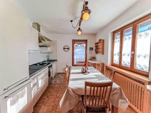 a kitchen with a table and chairs in a room at Apartment Casa Dalpi by Interhome in Predazzo +45 photos