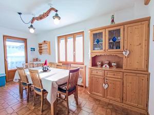 a dining room with a table and chairs at Apartment Casa Dalpi by Interhome in Predazzo