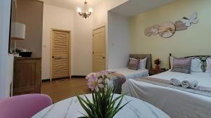 a bedroom with two beds and a table and chairs at RIVERBANK SUITE with riverfront mountain DUN view in Kuching +10 photos