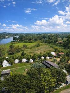 an aerial view of a field with tents and a river at The Campster Kanchanaburi in Kanchanaburi City