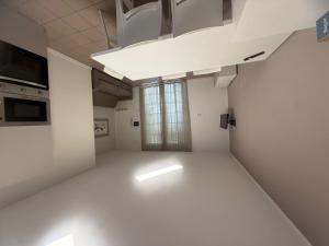 an empty room with white floors and a window at Holiday Home Veranda-2 by Interhome in Rosapineta +15 photos