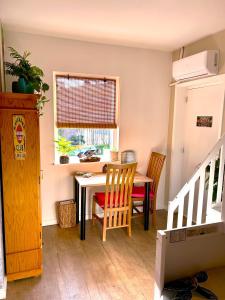 a dining room with a table and chairs and a window at Costa Linda B&B in Vlissingen