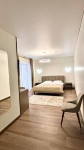 a bedroom with a bed and a chair at Continental SPA in Palyanytsya