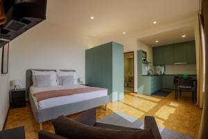 a bedroom with a bed and a living room at Casa de Cristal by Oporto Soul in Porto