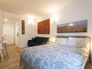 a bedroom with a bed and a couch at Studio Studio T by Interhome in Bormio