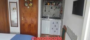 a small kitchen with a sink and a stove at Sperlonga Tiny Room in Sperlonga