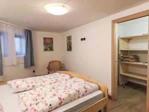 a bedroom with a bed and a mirror at Apartment Cesa Cristina by Interhome in Campitello