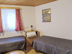 a hotel room with two beds and a window at Apartment Cesa Cristina by Interhome in Campitello