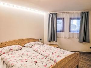 a bedroom with a bed and a window at Apartment Cesa Cristina by Interhome in Campitello