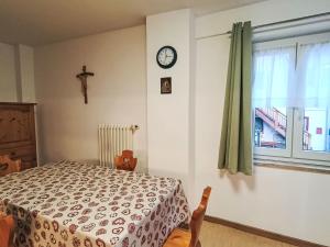 a bedroom with a bed and a clock on the wall at Apartment Cesa Cristina by Interhome in Campitello +25 photos