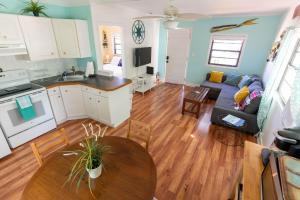 a kitchen and living room with a couch and a table at Cindy Villa in Key Largo +12 photos
