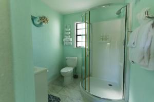a bathroom with a shower and a toilet at Cindy Villa in Key Largo