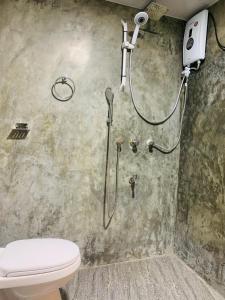 a shower in a bathroom with a toilet at Samson's Home in Hiriketiya