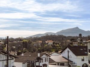 a city with houses and mountains in the background at Apartment Barasteguia by Interhome in Ciboure
