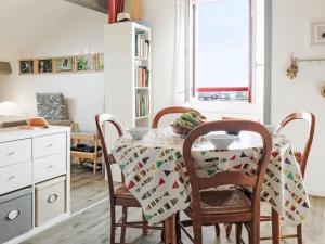 a dining room table with chairs and a table cloth at Apartment Barasteguia by Interhome in Ciboure