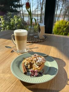 a plate of food on a table with a cup of coffee at Cyprianówka in Warszowice