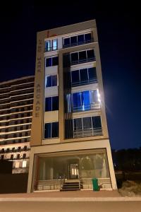 a tall building with a blue light in front of it at Stay Premium in Islamabad