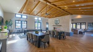 a dining room with tables and chairs and a fireplace at Summerwell by AvantStay in La Quinta