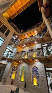 a building with stained glass windows and a ceiling at Shams Boutique Hotel in Bukhara
