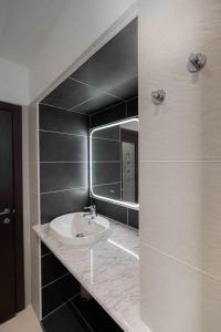 a bathroom with a sink and a mirror at Casa vacanza Garcia in Paluzza +15 photos