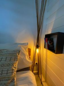 a bedroom with a bed and a tv on a wall at Emeraude tropicale in Goyave