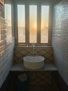 a bathroom with a sink and a window at Hotel Sukhdev in Nawalgarh