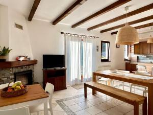 a kitchen and living room with a table and a dining room at Casa Bùri in Trarego