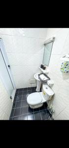 a bathroom with two sinks and a toilet at Lita Residence in Yaoundé +17 photos