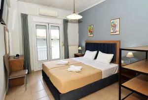 a bedroom with a bed with two towels on it at Studios Avra in Skala Rachoniou