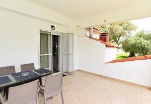 a dining room with a table and chairs and a window at Studios Avra in Skala Rachoniou +68 photos