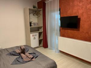 a teddy bear laying on a bed in a bedroom at PARAVANHouse in Constanţa