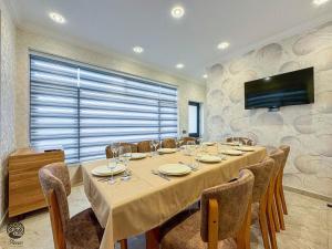 a dining room with a long table and chairs at River Hotel Restaurant in Quba +12 photos