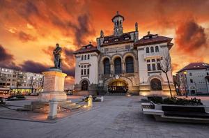 a large building with a statue in front of it at PARAVANHouse in Constanţa
