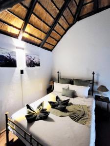 a bedroom with a bed with two flowers on it at Mukaya Haven in Marloth Park +17 photos