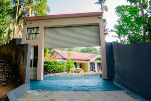 a garage door in front of a house at Zeylon Villa Talalla in Matara