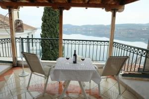 a table and chairs on a balcony with a view at Lacus Orestias - unlimited view in Kastoria