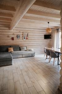 a living room with a couch and a table at Vila Mila in Mykulychyn