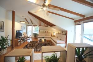 a living room with a couch and a ceiling fan at Lacus Orestias - unlimited view in Kastoria