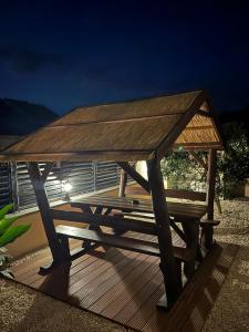a wooden picnic table on a deck at night at BCM Weidinger in Mirce