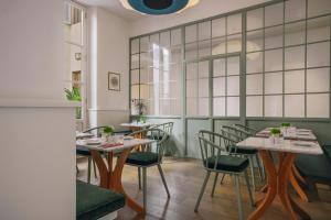 a restaurant with tables and chairs and a window at Casa G. Firenze in Florence