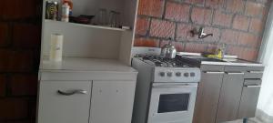 a small kitchen with a stove and a sink at Kallpa in Tinogasta +6 photos