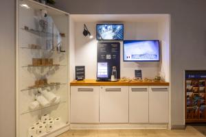 a shop with a counter and a tv on the wall at Pytloun Self Check-in Hotel Liberec in Liberec +52 photos