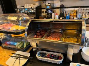 a buffet with a tray of food on a table at Rybaki Sauna & Jacuzzi Apartment in Poznań