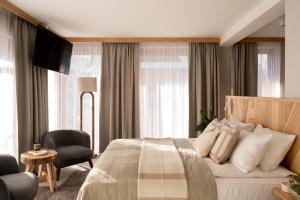 a hotel room with a bed and a chair at Nova Hill in Zakopane +44 photos