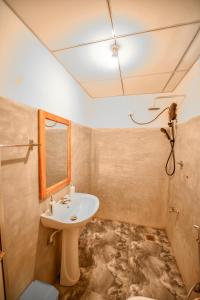 a bathroom with a sink and a mirror at Jungle View River Camping in Udawalawe +34 photos