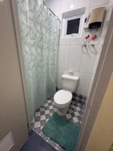 a small bathroom with a toilet and a shower at Belechl Ranch Studio Rental - Cozy Compact Room with Private Bathroom in Koror +31 photos