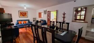 a living room with a table and a blue couch at The Green Corner Urubamba in Urubamba