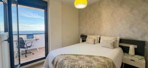 a bedroom with a bed with a view of a balcony at La Cala Center Premium Penthouse Motorized Terrace & Sea Views in La Cala de Mijas