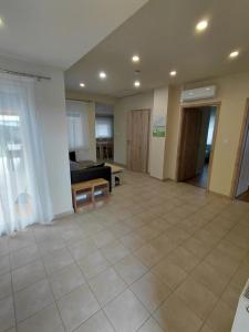a living room with a couch and a table at Borti Apartman in Zamárdi