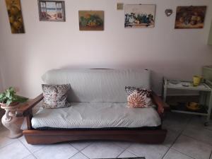 a couch in a living room with pillows on it at Casafreccia in Carloforte